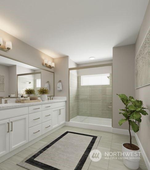 bathroom with tile patterned flooring, a shower with shower door, and vanity