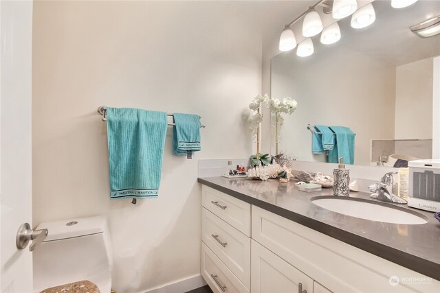 bathroom with vanity and toilet