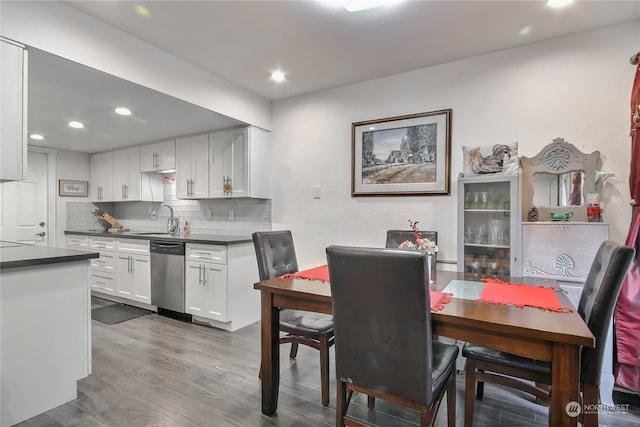 dining room with dark wood-style flooring and recessed lighting