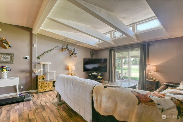 living room with hardwood / wood-style flooring and lofted ceiling with beams