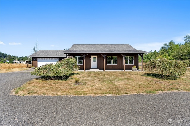 ranch-style house with a garage and a front yard