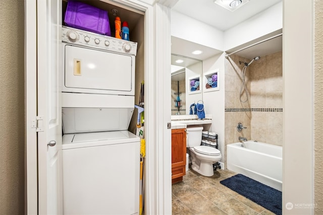 laundry area with stacked washer and clothes dryer and light tile patterned floors