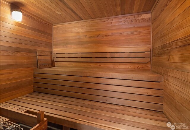 view of sauna / steam room featuring wooden walls and wooden ceiling