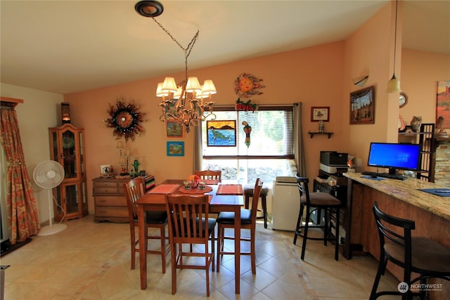 dining area with light tile patterned floors and an inviting chandelier