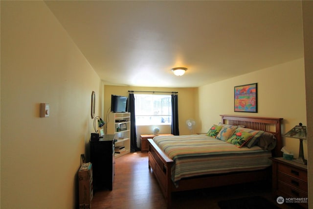 bedroom with dark wood-style flooring