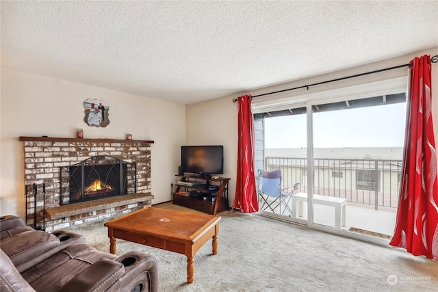 carpeted living room featuring a textured ceiling and a fireplace