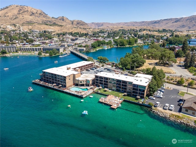 birds eye view of property with a water and mountain view