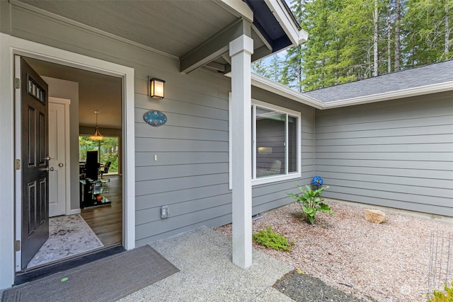 property entrance with a shingled roof