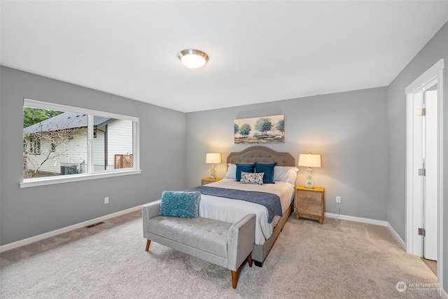 bedroom featuring light colored carpet, visible vents, and baseboards