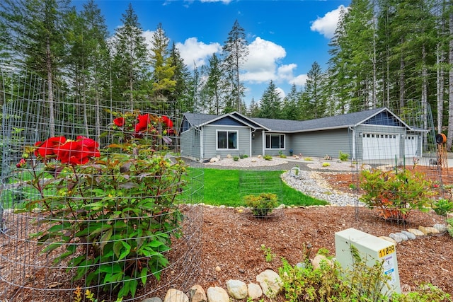 view of front of house with a garage and a front lawn