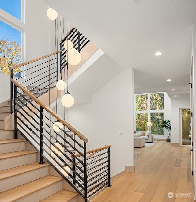 staircase with hardwood / wood-style floors