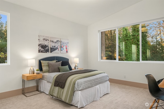 carpeted bedroom with vaulted ceiling