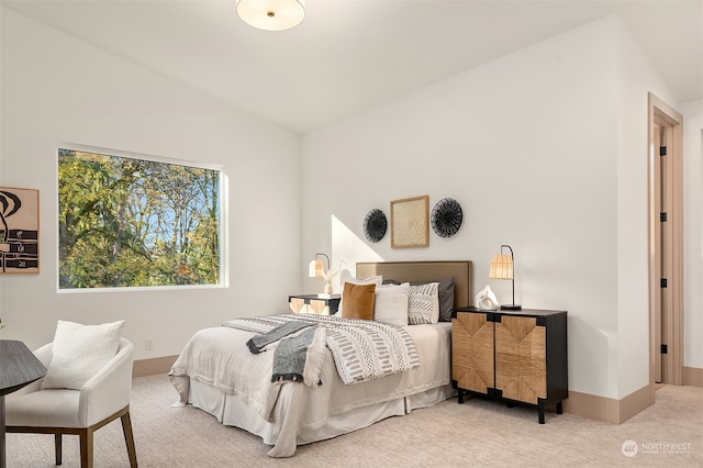 carpeted bedroom featuring lofted ceiling