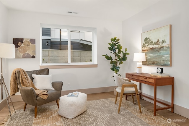 sitting room featuring light hardwood / wood-style flooring