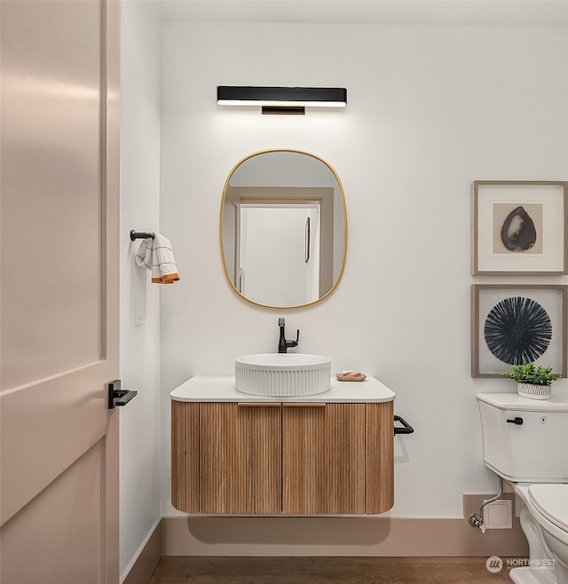 bathroom featuring toilet and vanity