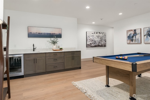 playroom with billiards, light hardwood / wood-style flooring, wet bar, and beverage cooler