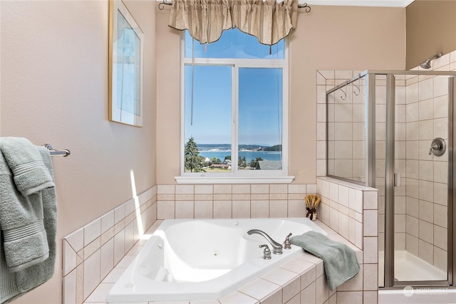 bathroom featuring separate shower and tub and a water view