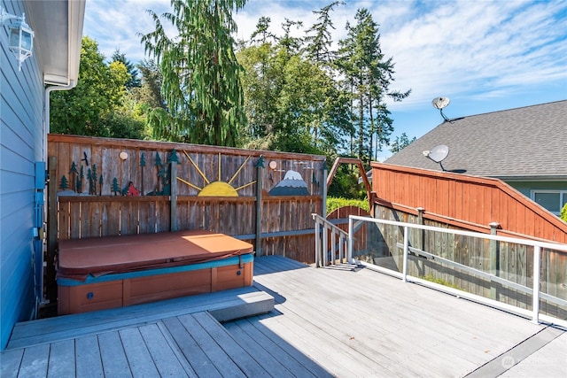 wooden terrace featuring a hot tub