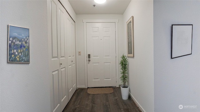 corridor with dark hardwood / wood-style flooring