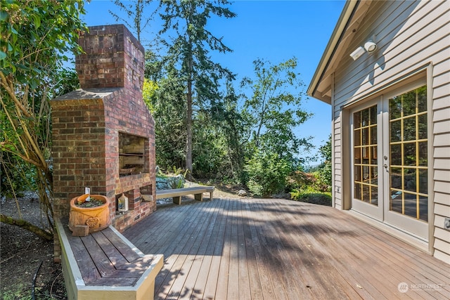 wooden terrace with a fireplace