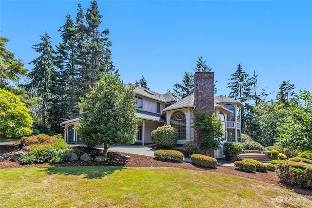 obstructed view of property featuring a front lawn