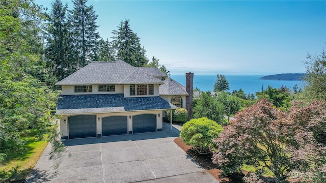 view of property with a water view and a garage