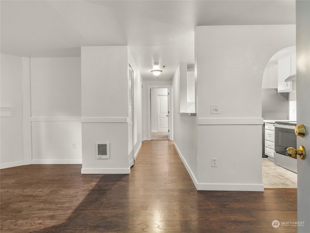 corridor with hardwood / wood-style floors