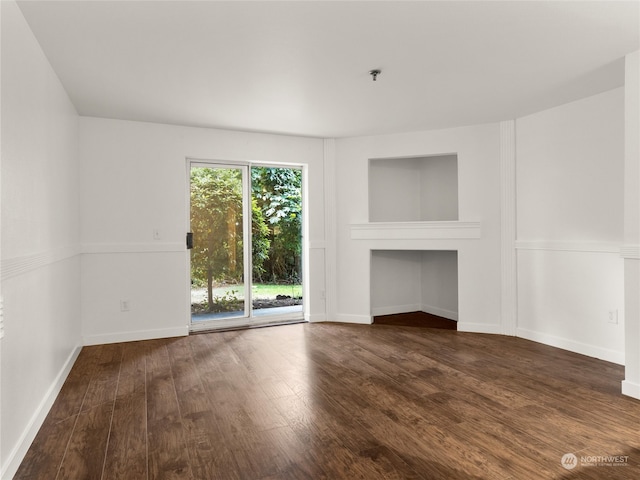 unfurnished living room featuring dark wood-type flooring