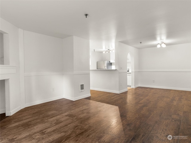 unfurnished living room featuring dark hardwood / wood-style flooring