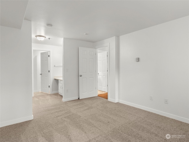 unfurnished bedroom featuring light colored carpet