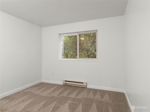 carpeted spare room featuring baseboard heating