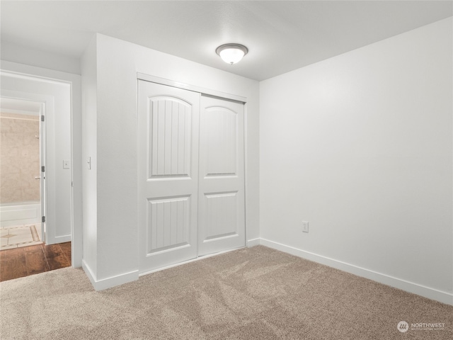 unfurnished bedroom featuring a closet and carpet flooring