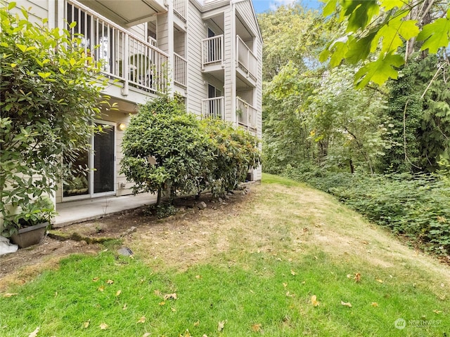 view of yard with a balcony