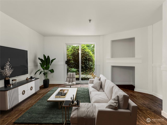 living room with dark hardwood / wood-style floors and a fireplace