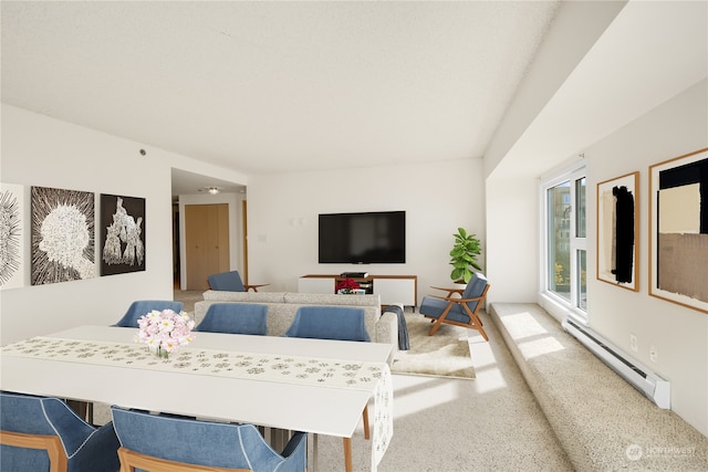 carpeted dining area with a baseboard radiator