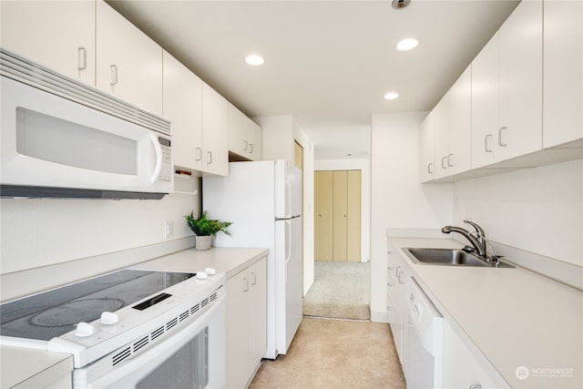 kitchen featuring sink, white cabinets, and white appliances