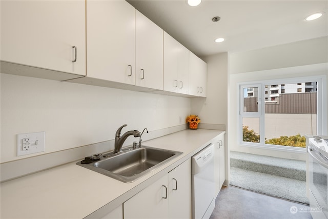 kitchen featuring sink, white appliances, and white cabinets