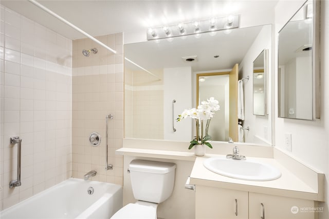 full bathroom featuring vanity, toilet, and tiled shower / bath