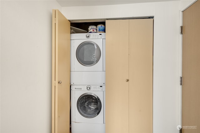 laundry area featuring stacked washer / drying machine