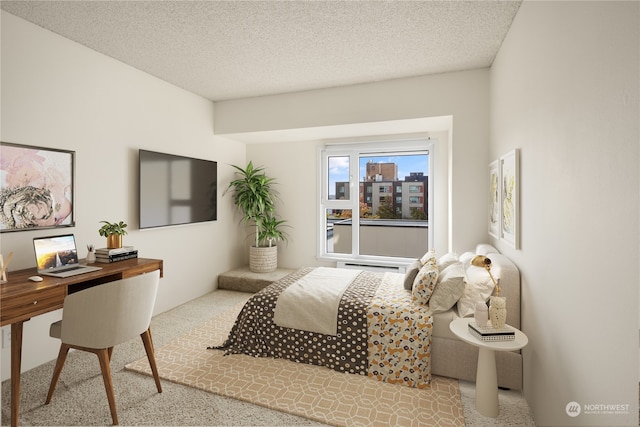 bedroom with light colored carpet and a textured ceiling