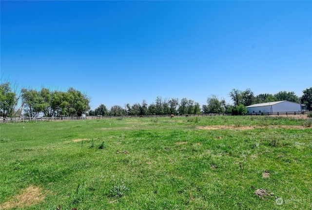 view of yard with a rural view