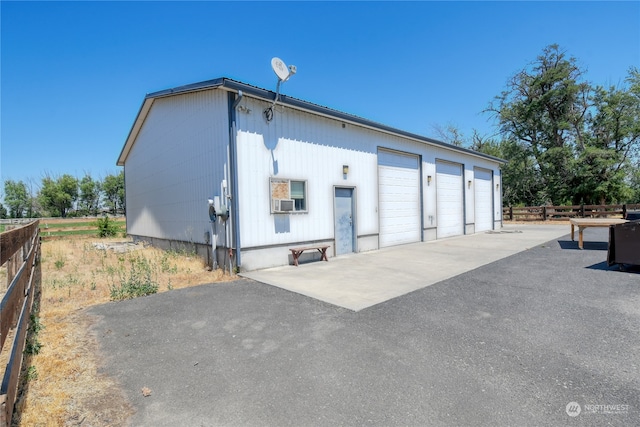 exterior space featuring a garage and an outdoor structure