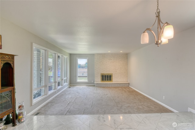 unfurnished living room with a fireplace, light carpet, a notable chandelier, and brick wall