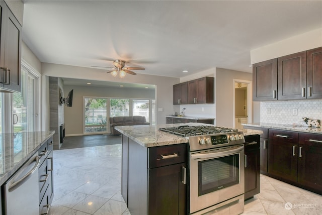 kitchen featuring gas stove, light tile patterned floors, white dishwasher, ceiling fan, and light stone countertops