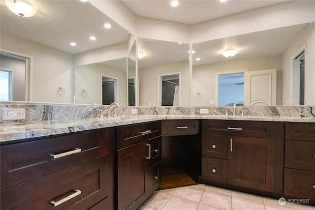 bathroom with dual vanity and tile patterned flooring