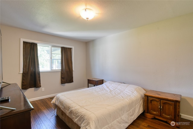 bedroom featuring dark hardwood / wood-style flooring