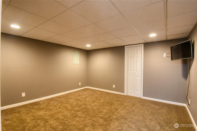 basement with a drop ceiling and carpet