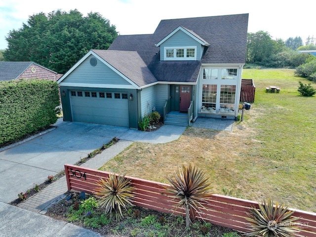 view of front of property with a garage and a front lawn