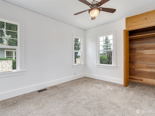 unfurnished room with ceiling fan and carpet floors