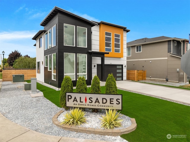 view of front facade featuring a garage and a front lawn